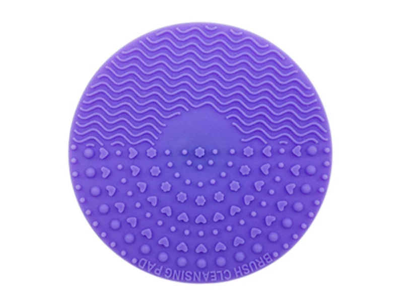 Purple oval makeup-brush cleaning mat with several textured zones