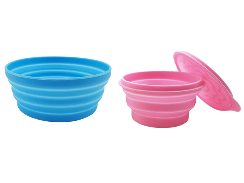 Blue open collapsible bowl and pink collapsible bowl with a lid